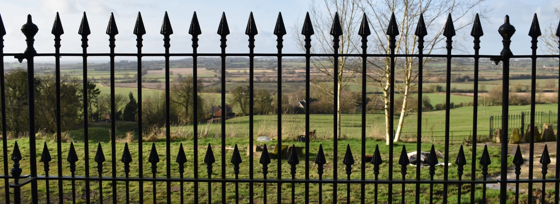 A beautiful countryside view through bespoke railings in Royal Wootton Bassett.