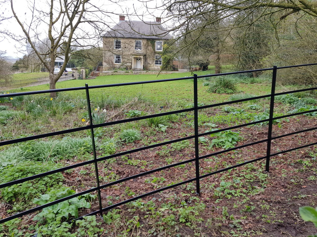 Traditional estate fencing in the English countryside.