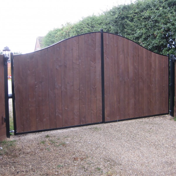 Wrought iron gates with wood inserts made and fitted by The Blacksmith Shop.