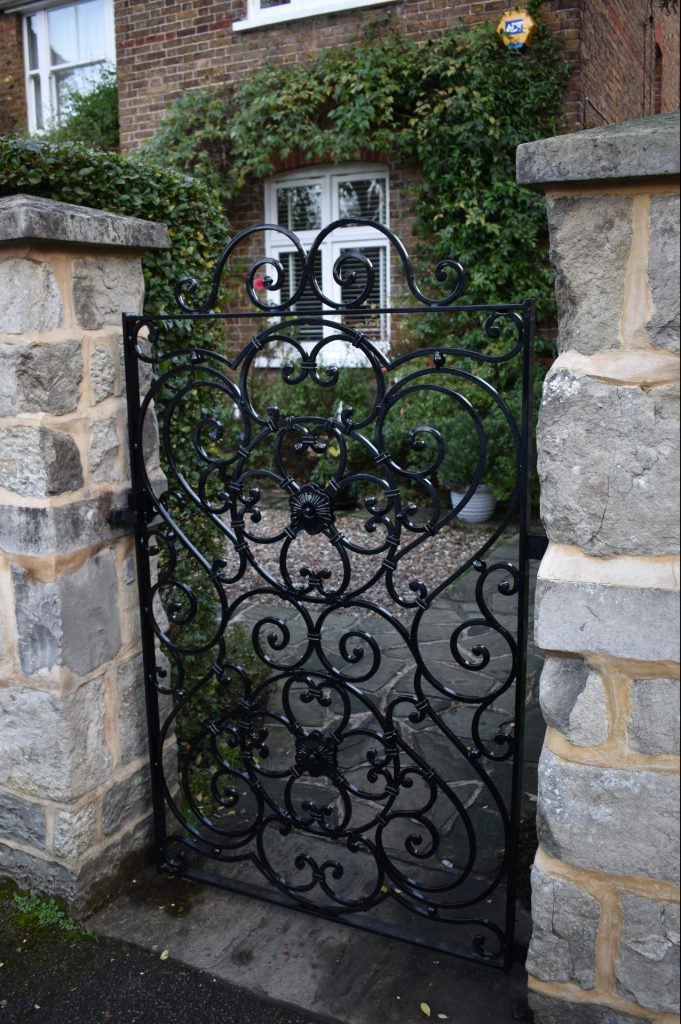 A wrought iron pedestrian gate made and fitted by The Blacksmith Shop.