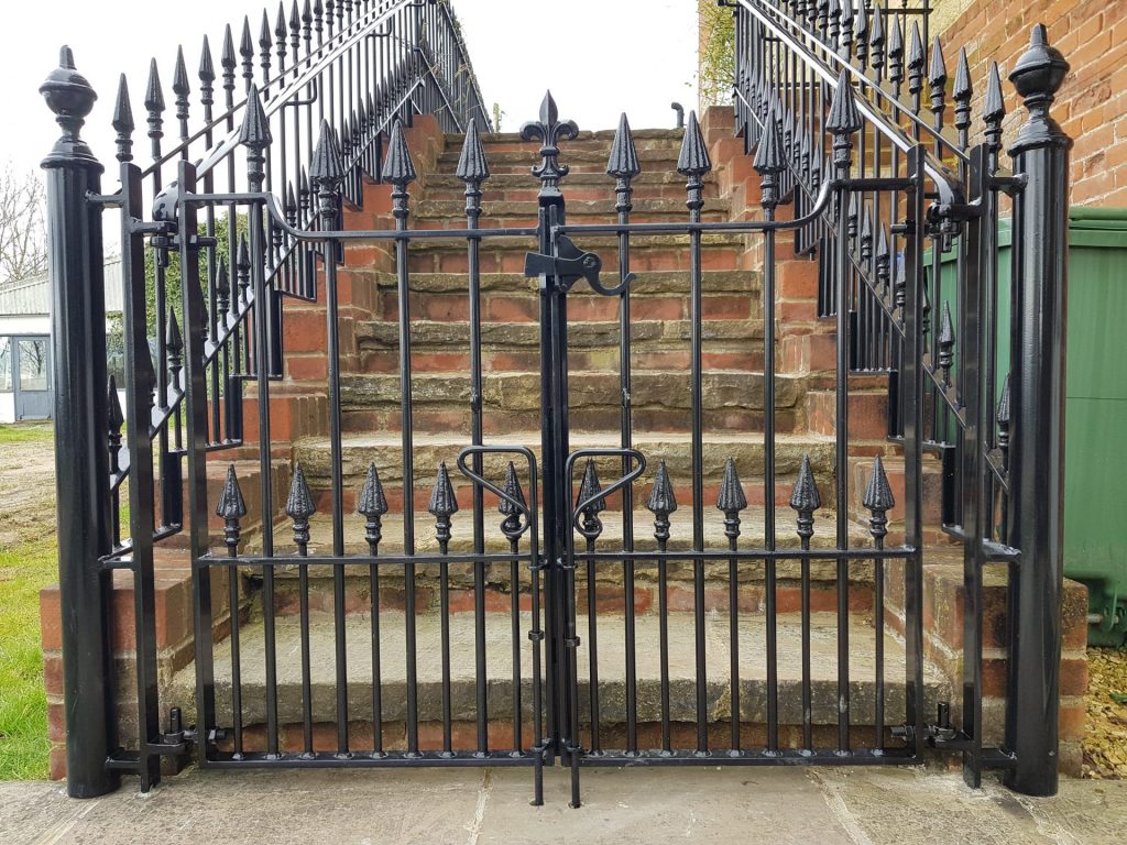 Exterior staircase with bespoke wrought iron gates and balustrades.