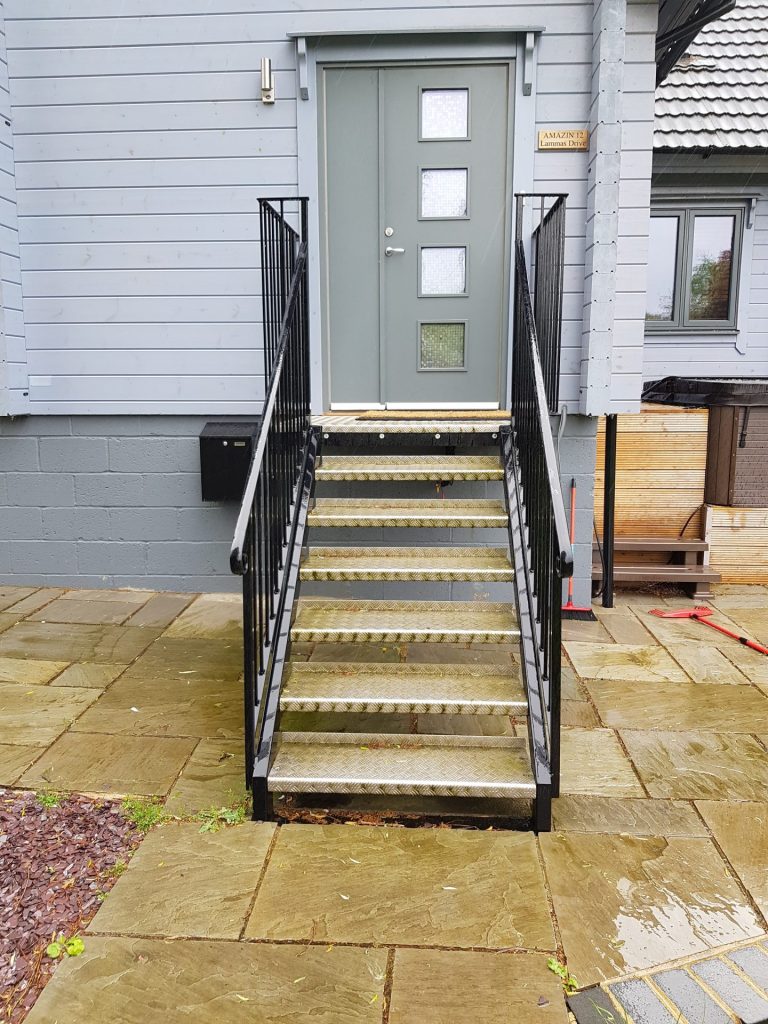 Aluminium chequer plate treads on external metal staircase.