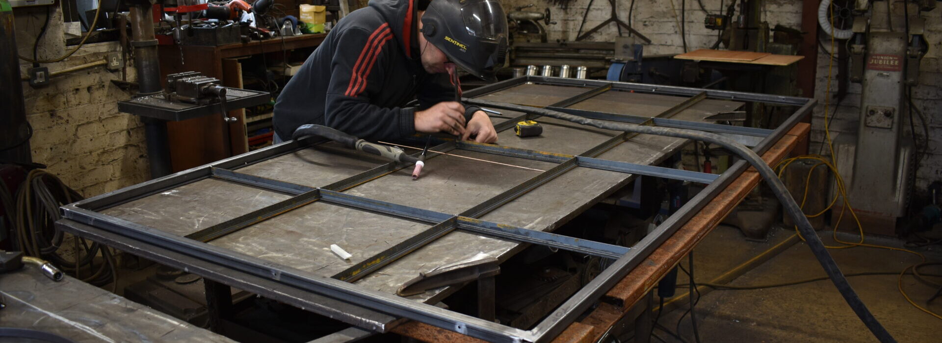 Making metal glazed internal doors and partitions in The Blacksmith Shop forge.