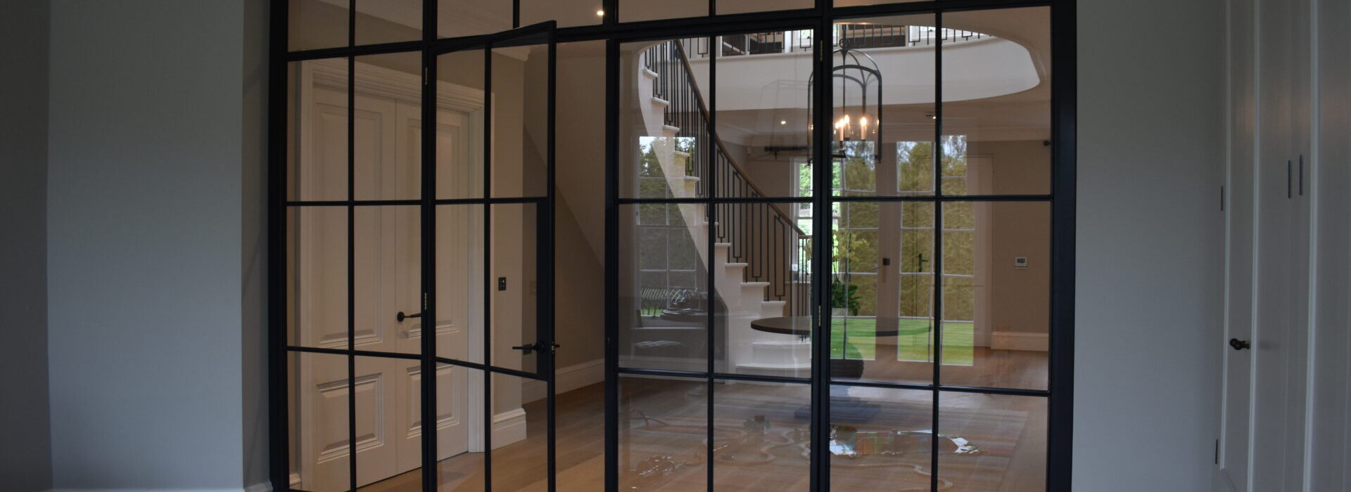 Stylish metal glazed internal partition with doors.