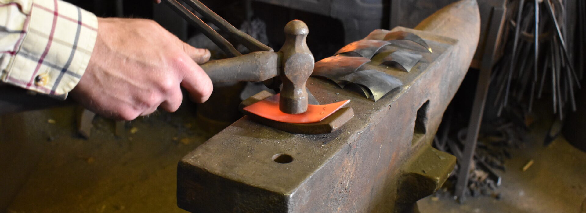Making bespoke metalwork on the blacksmith's anvil.