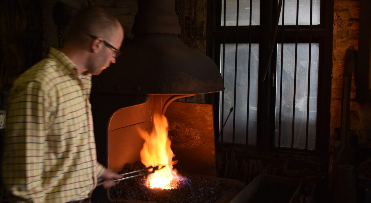 Working in the blacksmith's forge making bespoke metalwork.