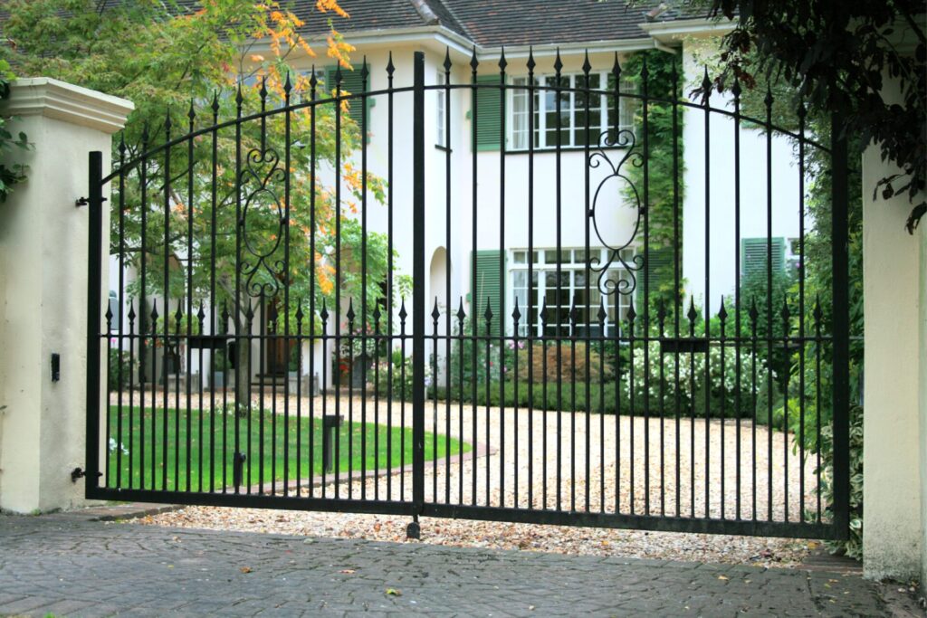 A pair of Farncombe wrought iron gates made and installed by The Blacksmith Shop.