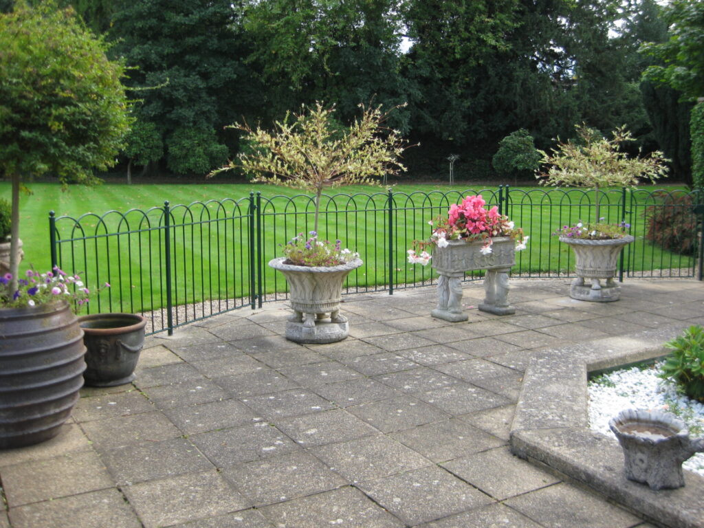 An overlapped hoop top wrought iron fence.